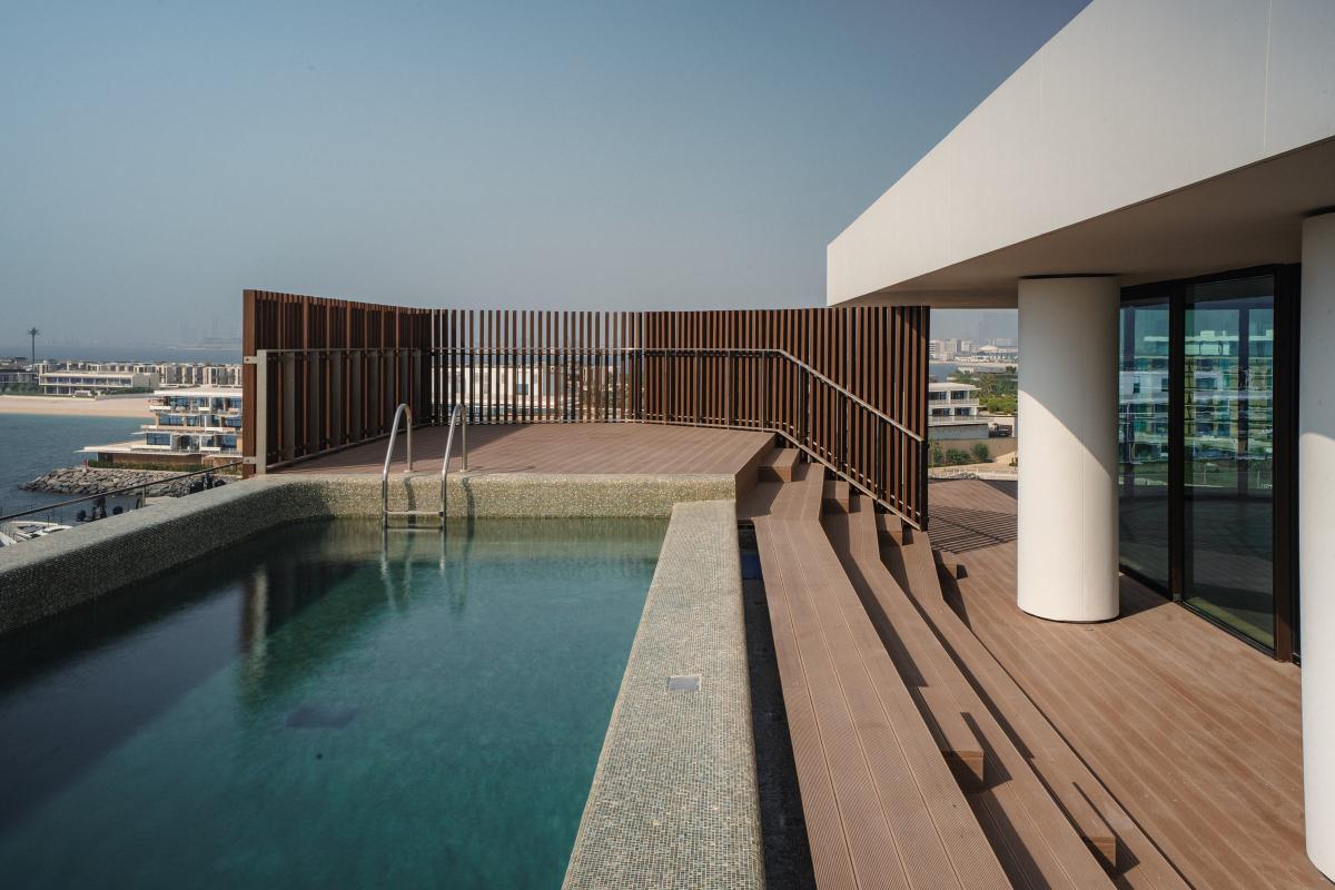 Rooftop pool terrace with a wood deck overlooking the marina, Bulgari Penthouse Building, Bulgari Island, Dubai