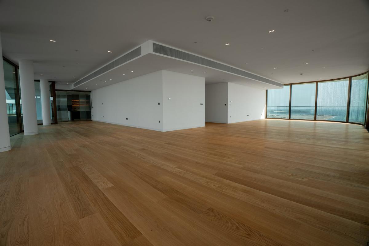 Empty open-plan living area with wood flooring, Bulgari Penthouse Building, Bulgari Island, Dubai
