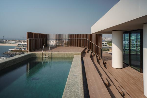 Rooftop infinity pool with a wood deck and a slatted timber screen, Bulgari Penthouse Building, Bulgari Island, Dubai