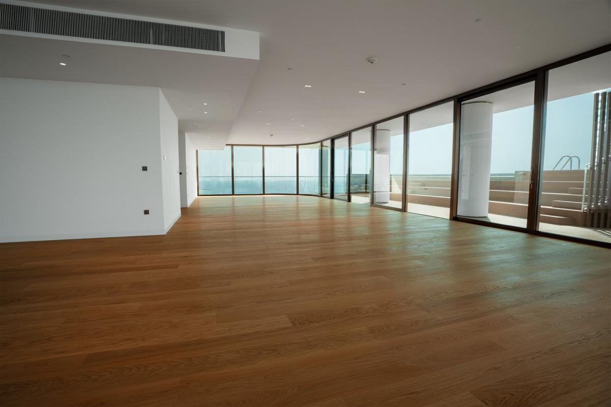 Empty curved living room with floor-to-ceiling windows, Bulgari Penthouse Building, Bulgari Island, Dubai