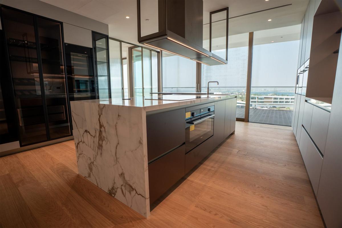 Kitchen with a marble island and dark wood cabinetry, Bulgari Penthouse Building, Bulgari Island, Dubai