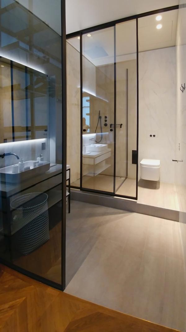 Bathroom with a glass shower partition and dual vanity, Duplex on Boulevard Saint-Germain, Paris