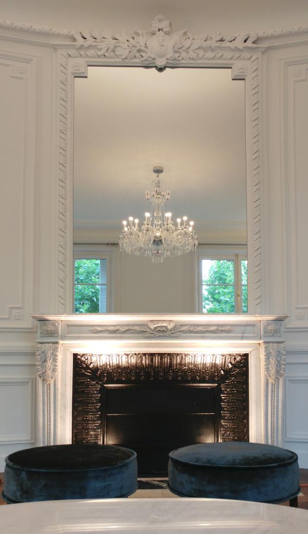 Marble fireplace mantel beneath a crystal chandelier, Duplex on Boulevard Saint-Germain, Paris
