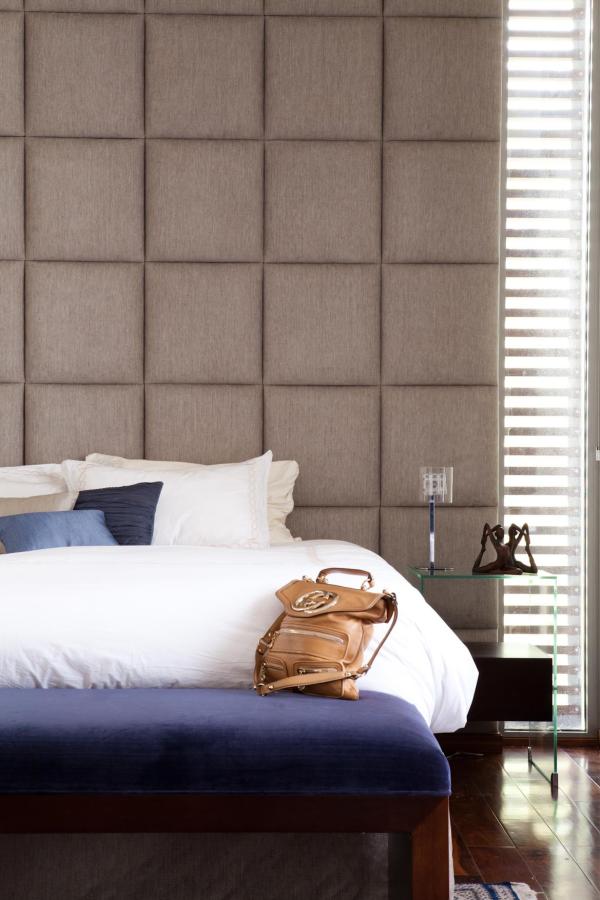 Bedroom with a tall tufted headboard and white bedding with a navy accent pillow, Emirates Hills Villa, Emirates Hills, Dubai