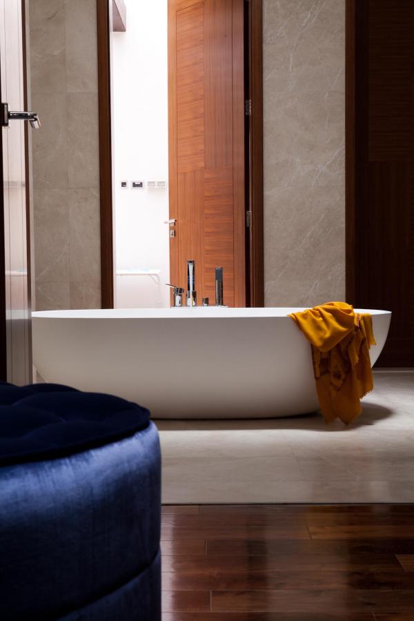 Bathroom with a freestanding oval tub and a mustard-yellow towel, Emirates Hills Villa, Emirates Hills, Dubai
