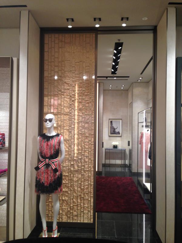 Window display with a mannequin in a red dress and a travertine wall, Fendi Boutique Shop, Mall of the Emirates, Dubai