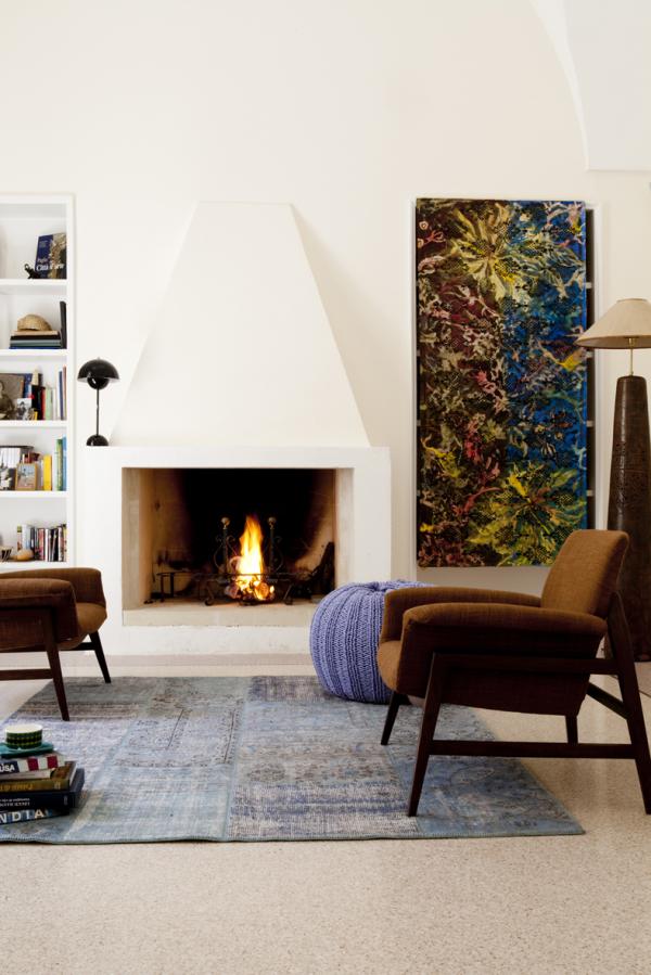 Living room with a lit fireplace and a bright abstract painting, Historical Apartment in Puglia, Lecce, Puglia