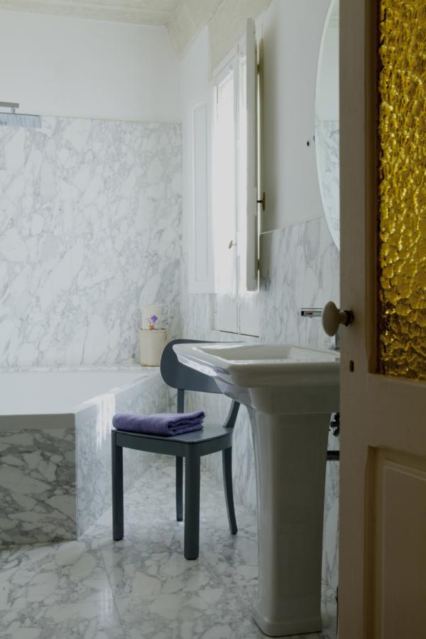 Bathroom with marble walls, a freestanding tub, and a pedestal sink, Historical Apartment in Puglia, Lecce, Puglia