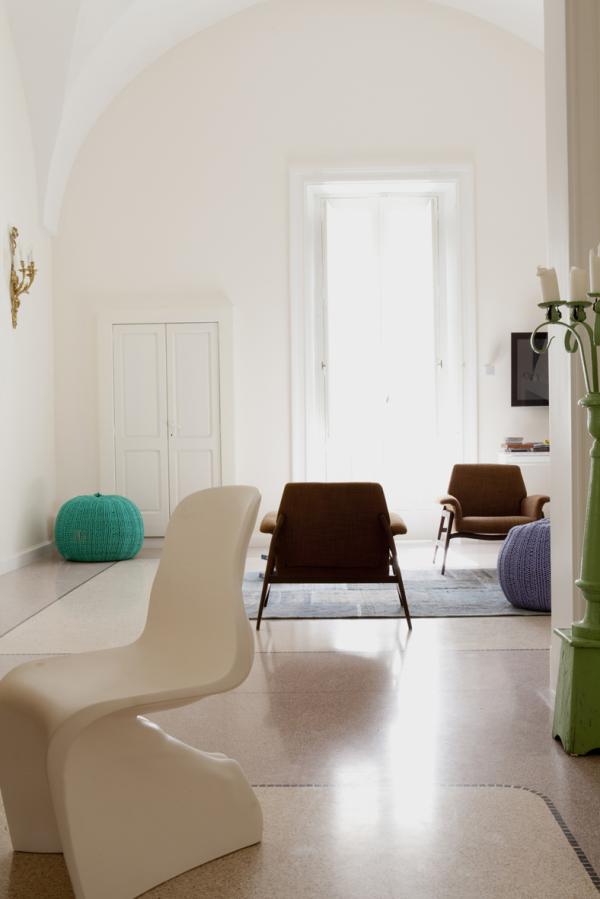Living room with brown armchairs and a teal pouf on a rug, Historical Apartment in Puglia, Lecce, Puglia