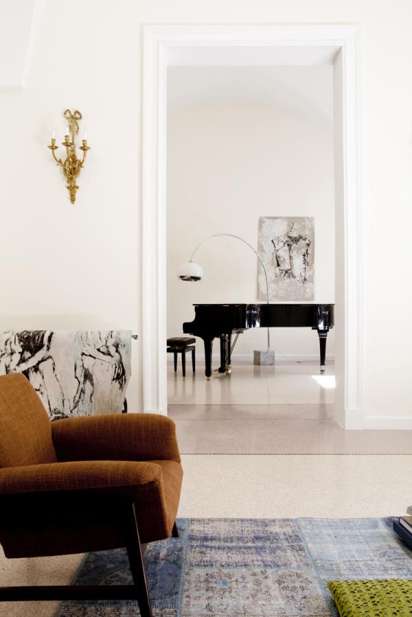 Living room with a grand piano seen through an archway, Historical Apartment in Puglia, Lecce, Puglia