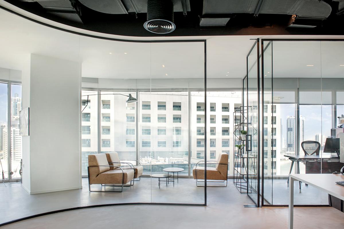 Glazed office corner with an exposed ceiling and a city view, Man Corporate Office, Binary Tower by Omniyat, Business Bay, Dubai