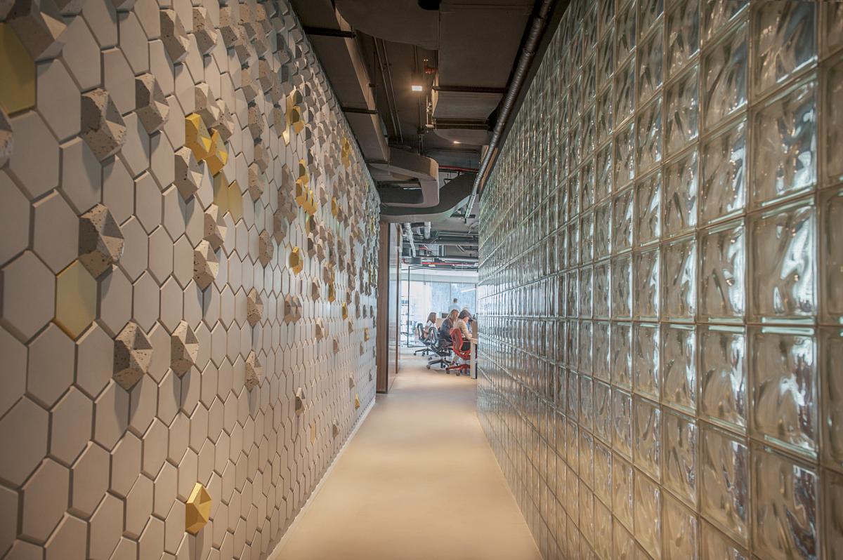 Corridor with a honeycomb tile wall and a glass-block partition, Man Corporate Office, Binary Tower by Omniyat, Business Bay, Dubai