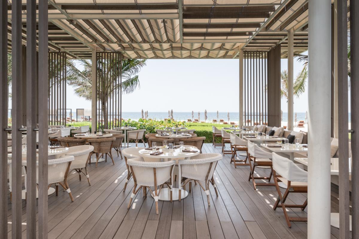 Beachfront restaurant terrace with timber pergola and sea view, Oberoi Resort, Ajman