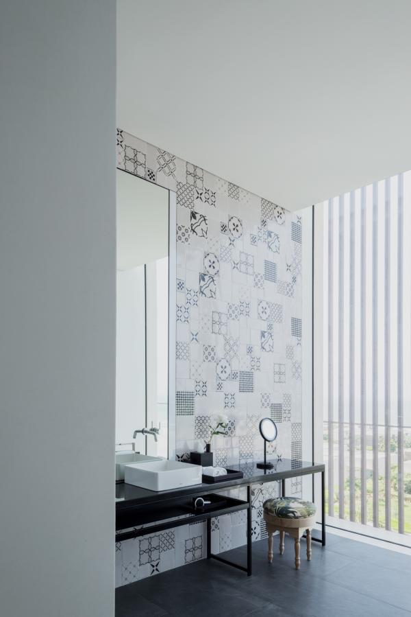 Bathroom with patterned tile wall and glass shower, Oberoi Resort, Ajman