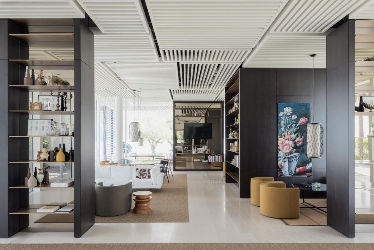 Hotel lobby lounge with bookshelf partition and artwork, Oberoi Resort, Ajman