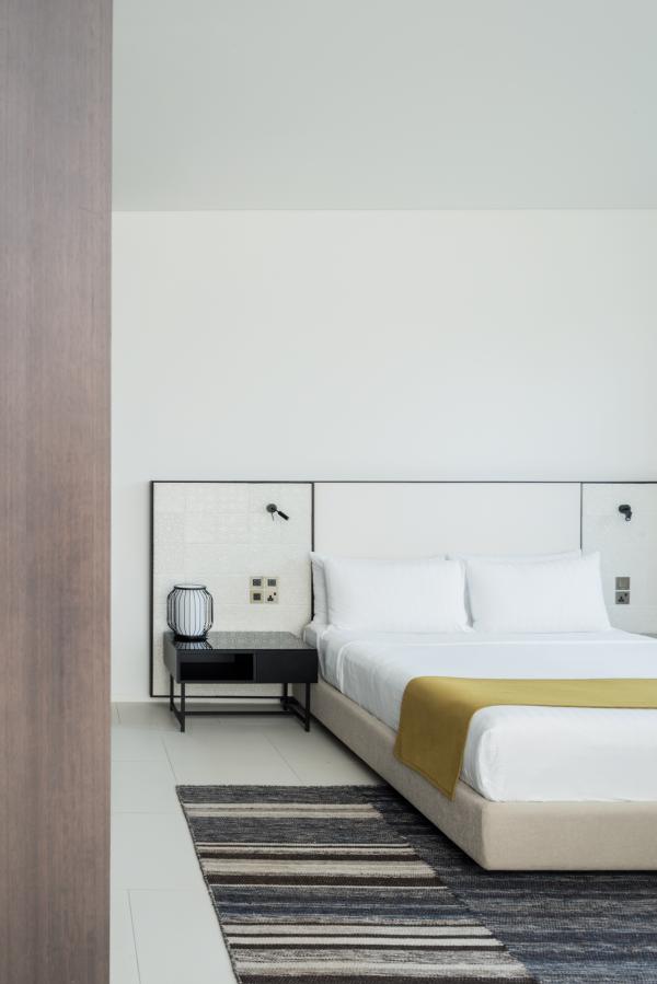 Bedroom with a tiled headboard wall, Oberoi Resort, Ajman