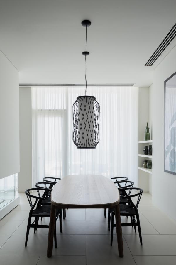 Dining nook with a black pendant light and sheer curtains, Oberoi Resort, Ajman