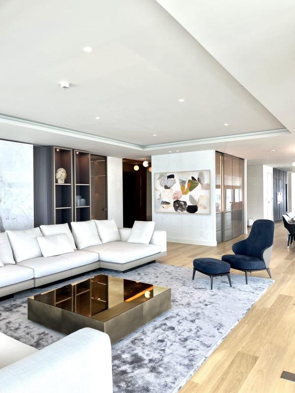 Living room with white sectional sofas and blue accent armchairs, One at Palm, Four Bedrooms, Palm Jumeirah, Dubai