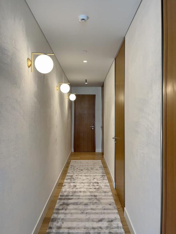 Corridor with wood-panelled doors and wall sconces, One at Palm, Four Bedrooms, Palm Jumeirah, Dubai
