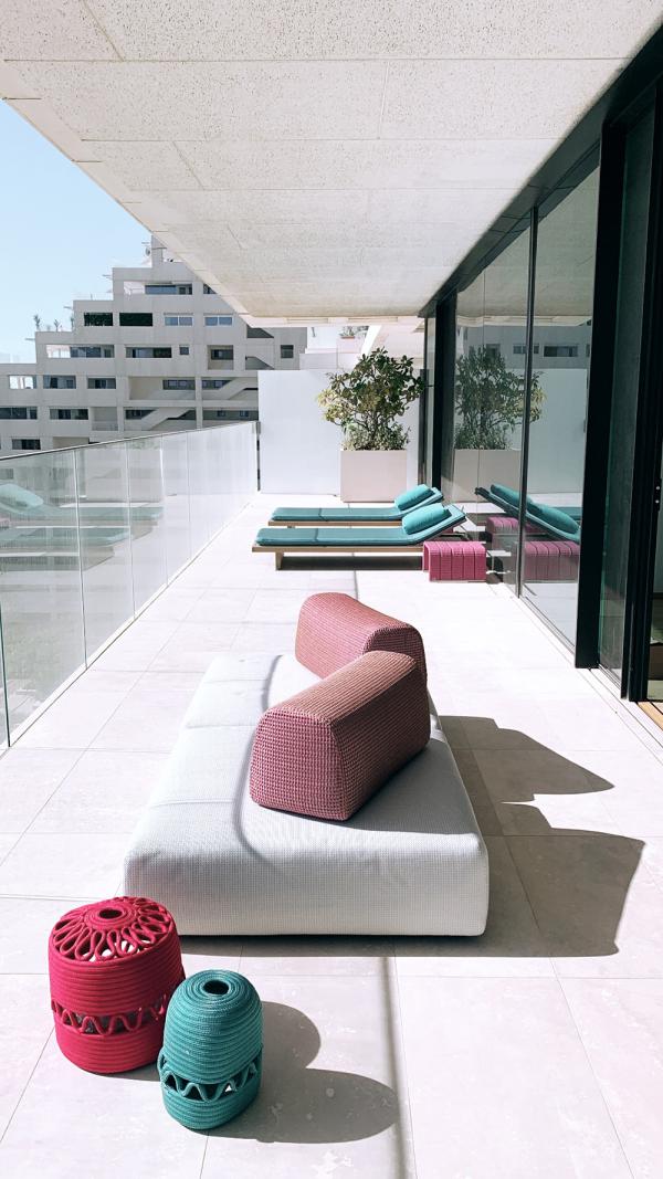 Rooftop terrace with a daybed and colourful poufs overlooking the skyline, One at Palm, Four Bedrooms, Palm Jumeirah, Dubai