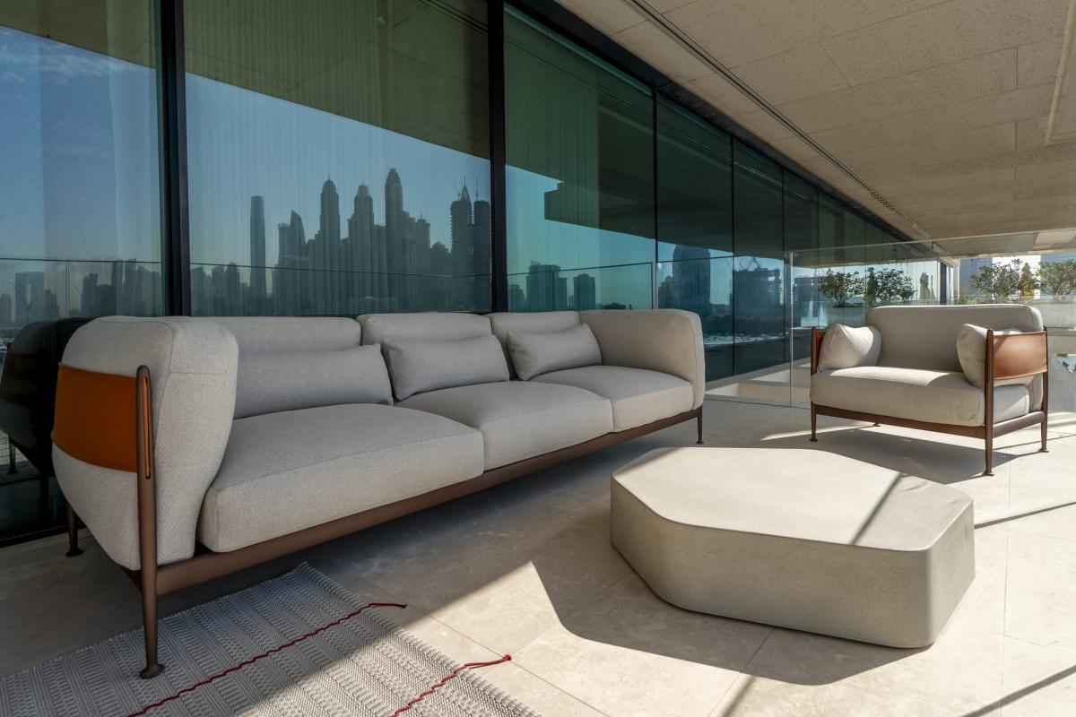 Living room with a grey sofa and armchairs on a terrace overlooking the marina, One at Palm, Three Bedrooms (Central Wing), Palm Jumeirah, Dubai