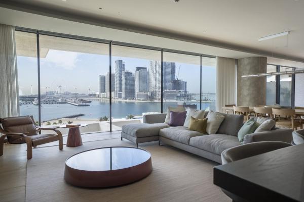 Living room with grey sofas, a round rust-toned coffee table, and floor-to-ceiling windows over the marina, One at Palm, Three Bedrooms (Central Wing), Palm Jumeirah, Dubai