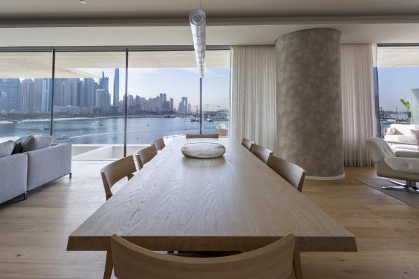 Dining area with a wood table and floor-to-ceiling windows over the marina, One at Palm, Three Bedrooms (Central Wing), Palm Jumeirah, Dubai