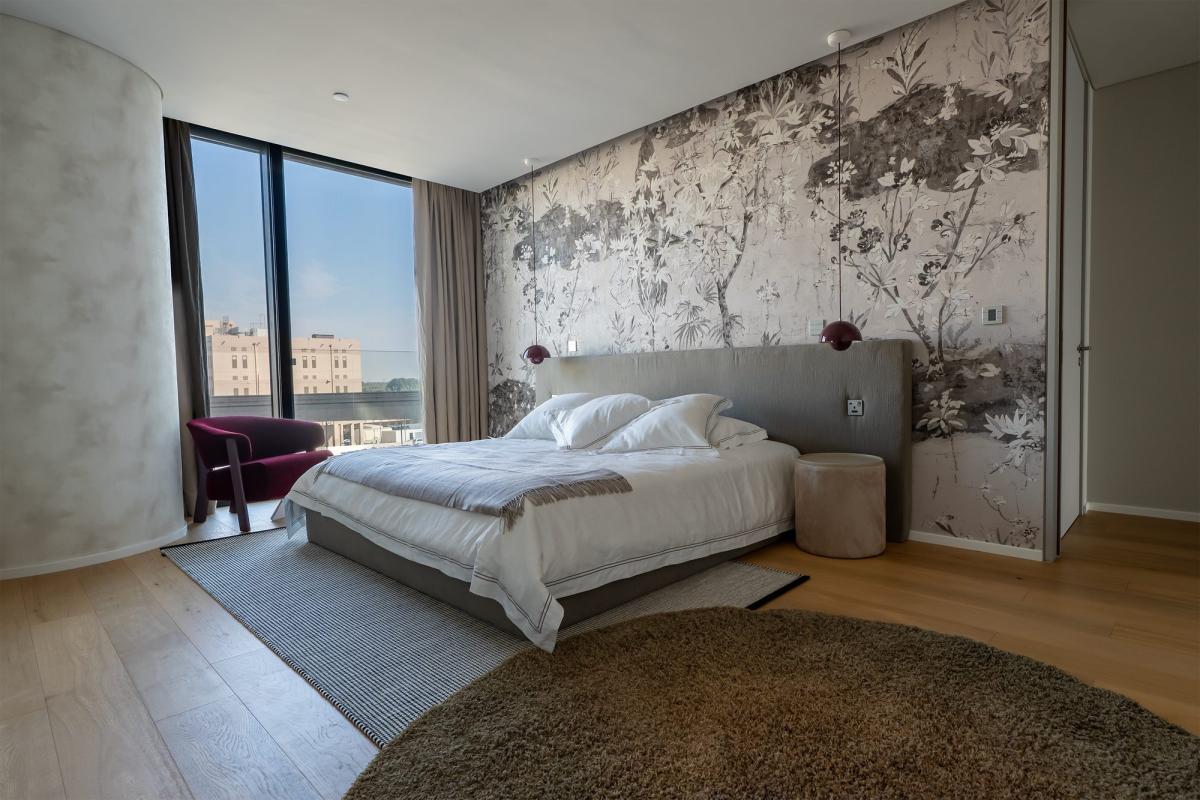 Bedroom with a tufted grey headboard, a plum accent chair, and a textured wallpaper wall, One at Palm, Three Bedrooms (Central Wing), Palm Jumeirah, Dubai