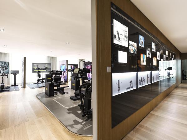 Showroom corridor with a backlit product display wall, Technogym Headquarters, Dubai