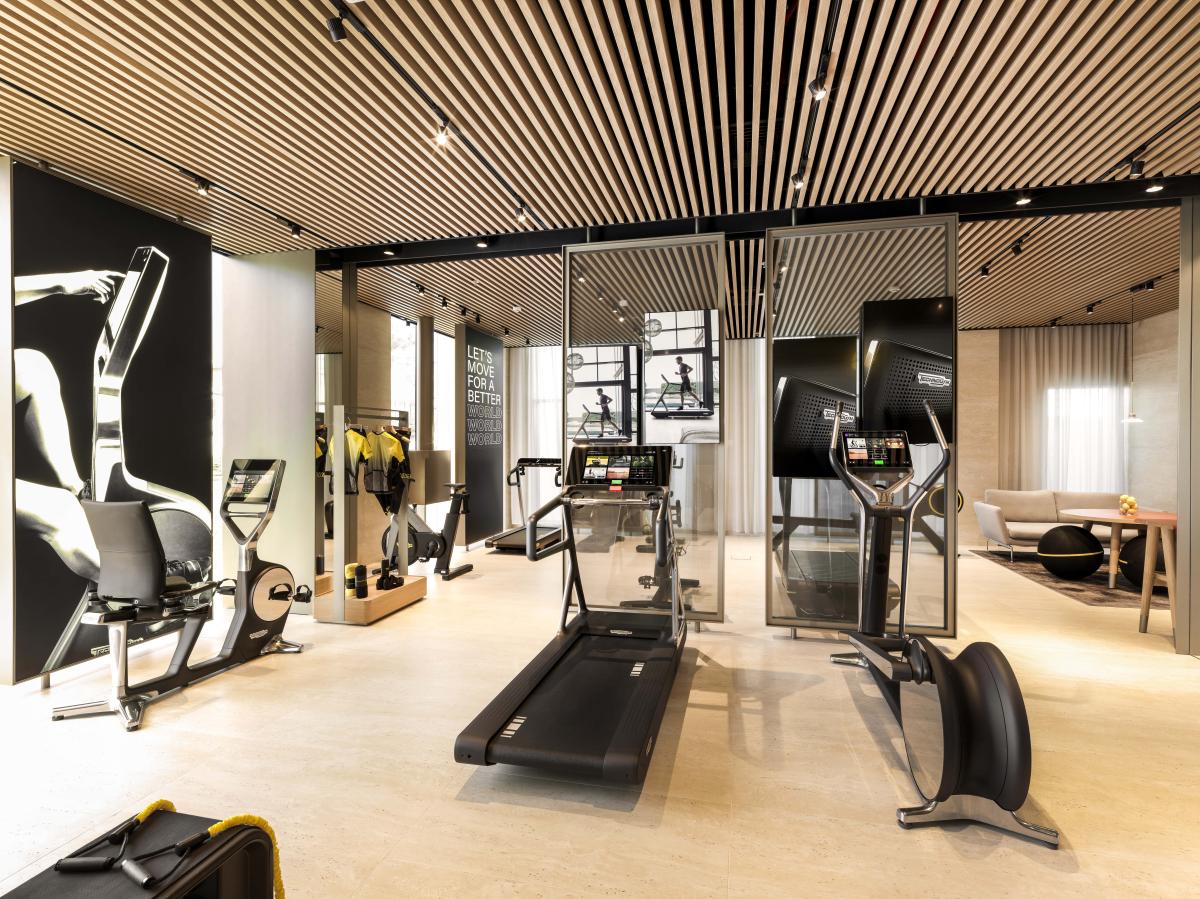 Showroom floor with treadmills under a slatted wood ceiling, Technogym Headquarters, Dubai