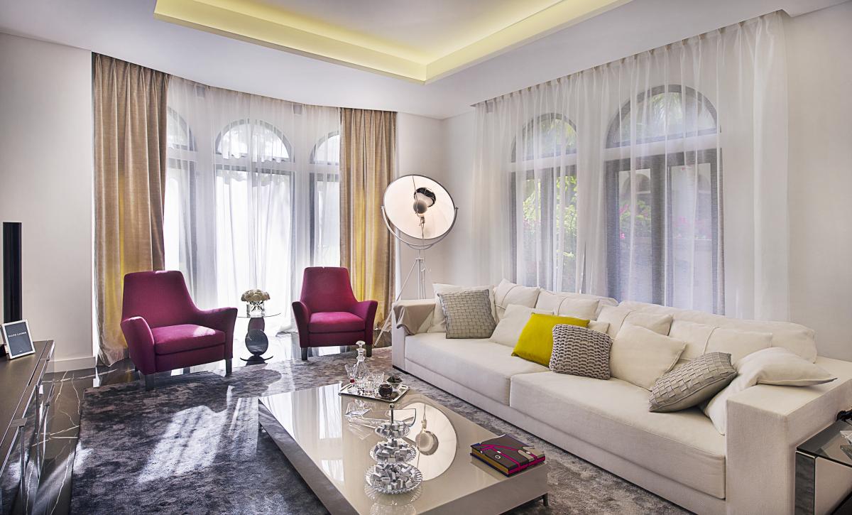Living room with arched windows and sofa seating, Villa Canal Cove, Palm Jumeirah