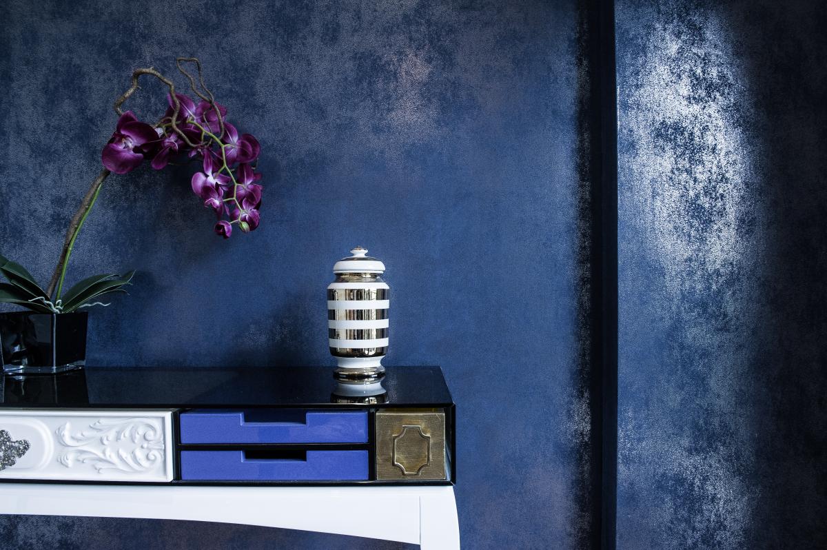 Console detail with a textured navy wall, orchids, and a blue lacquered cabinet, Zabeel Saray Resort Villa, Palm Jumeirah, Dubai