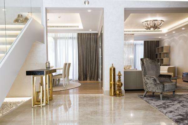 Open-plan living and dining area with a marble staircase and gold decorative jars, Zabeel Saray Resort Villa, Palm Jumeirah, Dubai