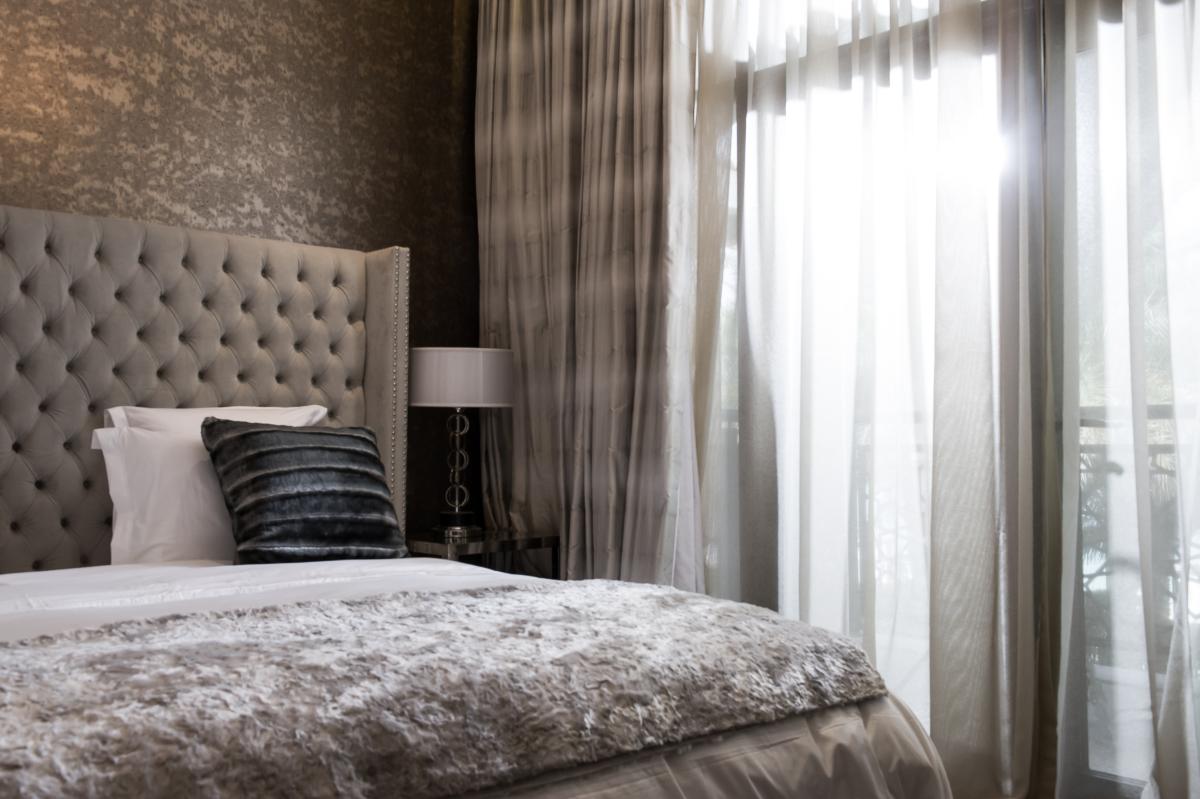 Bedroom with a grey tufted headboard and sheer curtains, Zabeel Saray Resort Villa, Palm Jumeirah, Dubai