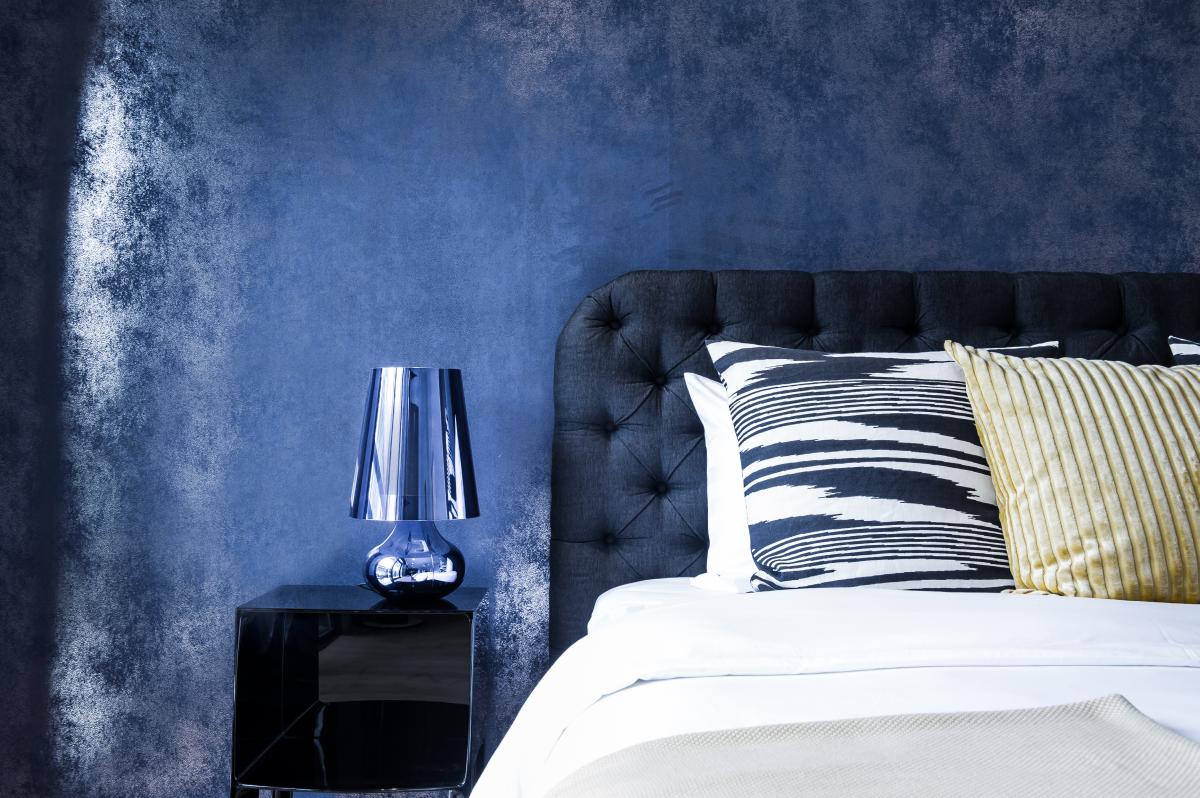 Bedroom with a dark tufted headboard, a navy textured wall, and patterned pillows, Zabeel Saray Resort Villa, Palm Jumeirah, Dubai
